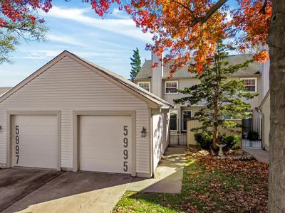 View of front of property featuring an outbuilding and a garage | Image 1