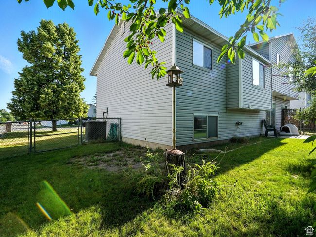 View of home's exterior featuring a gate and a central air condition unit | Image 25