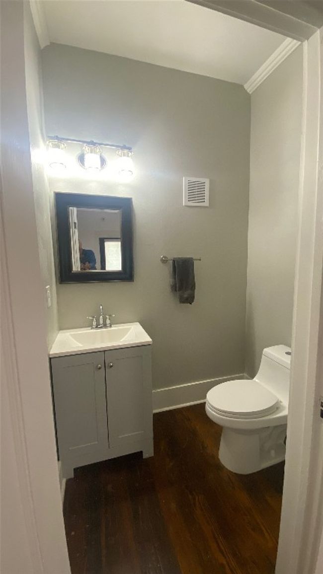 Bathroom featuring wood finished floors, vanity, and crown molding | Image 13