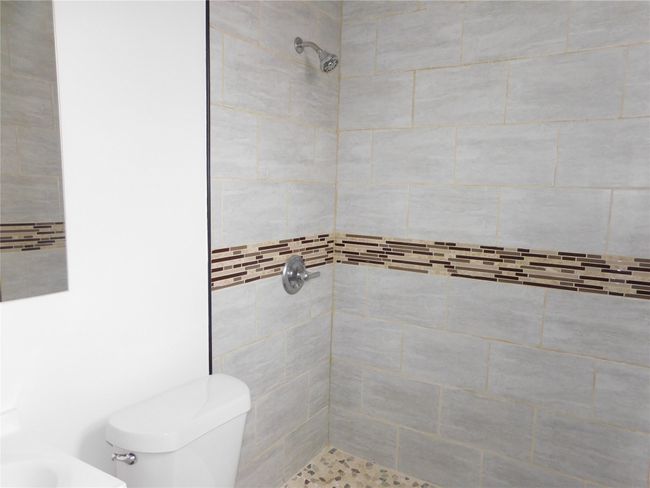 front primary bathroom ceramic tile shower | Image 22