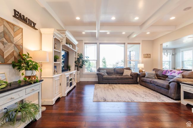 Living area featuring dark wood finished floors, beamed ceiling, coffered ceiling, recessed lighting, and a chandelier | Image 6