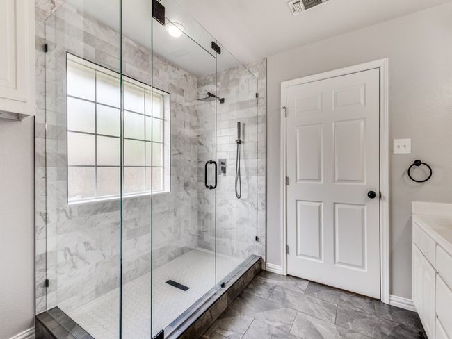 Full bath with a stall shower, vanity, marble finish floors, and baseboards | Image 20