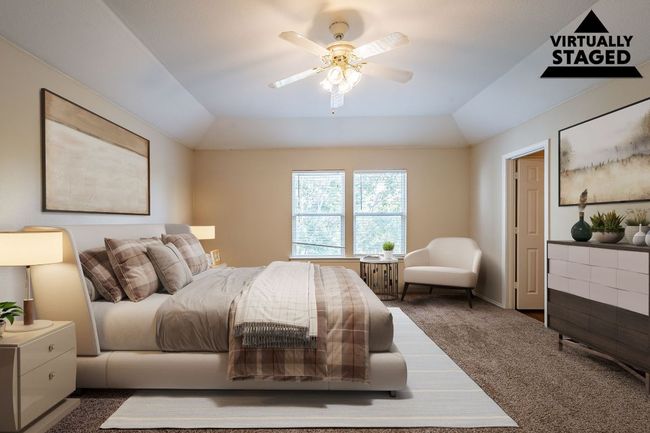 Bedroom featuring carpet floors, a tray ceiling, lofted ceiling, and a ceiling fan | Image 12