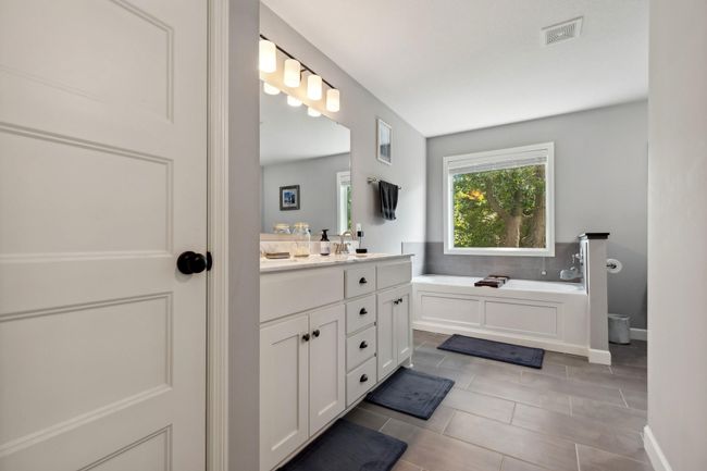 Owner's Bathroom features fresh paint, a linen closet, double sinks, soaker tub and separate shower. | Image 9