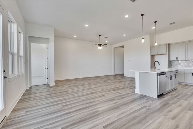 Kitchen with recessed lighting, dishwasher, a sink, decorative backsplash, and ceiling fan | Image 4