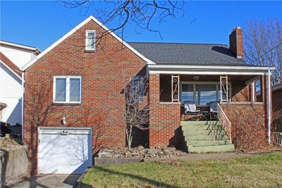 View of front facade with a garage and covered porch | Image 1