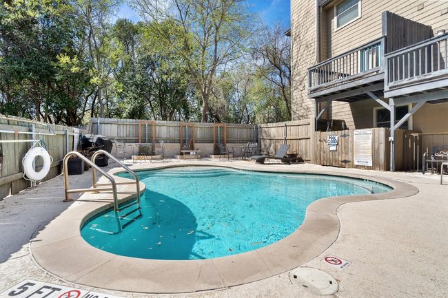 Surrounded by lush landscaping, the community pool offers a peaceful atmosphere, perfect for unwinding or socializing with neighbors. | Image 29