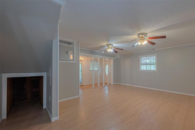Living room with entry to kitchen closet and additional storage under the stairs. | Image 12