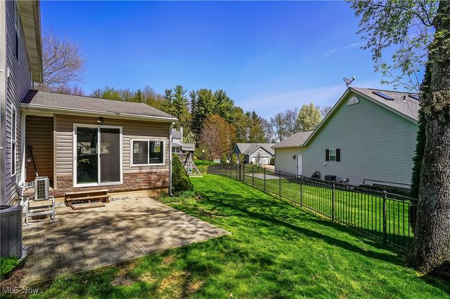 View of yard with a patio, entry steps, a fenced backyard, and central AC unit | Image 48