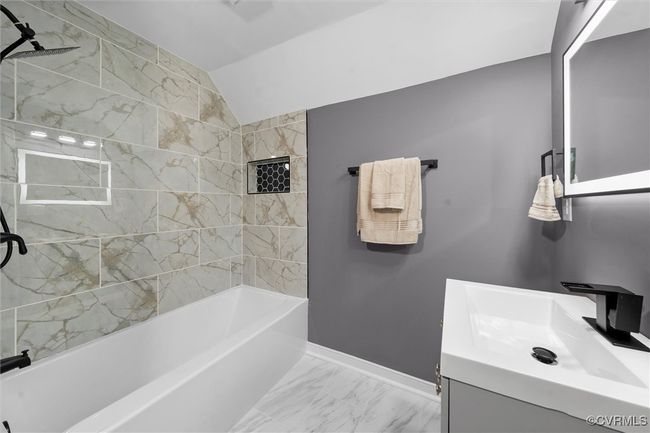 Full bathroom with marble finish flooring, vanity, lofted ceiling, and shower / bathtub combination | Image 28