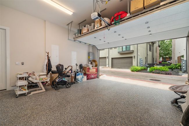 Custom shelving in garage, epoxy flooring, and ample power for electric car. | Image 29