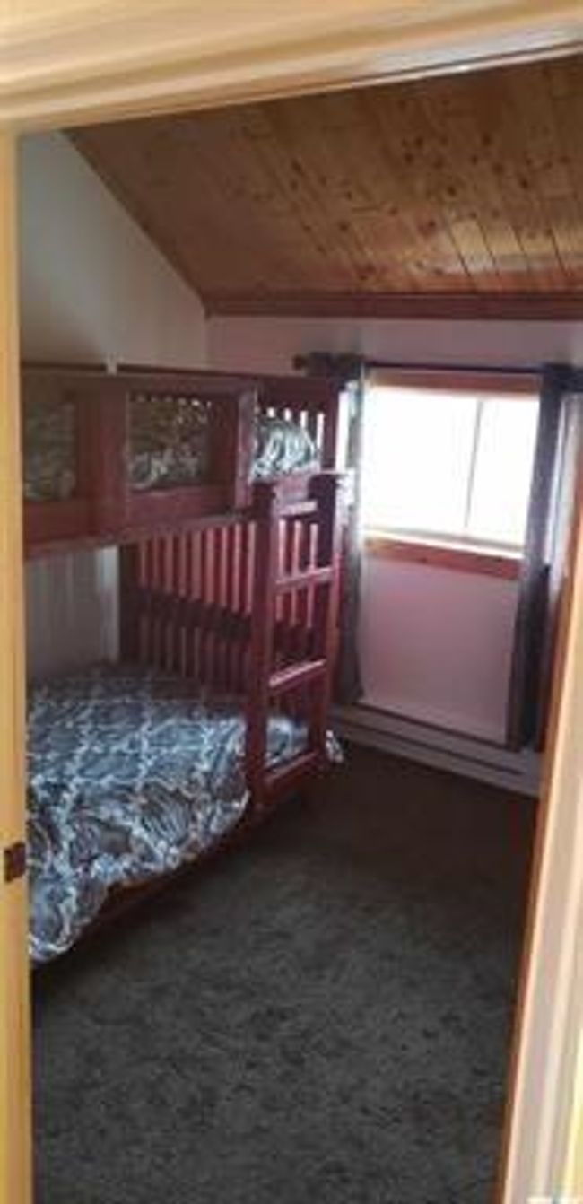 Bedroom featuring dark carpet, vaulted ceiling, and wood ceiling | Image 14