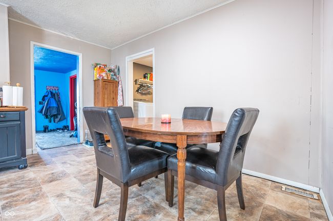 dining room featuring baseboards, visible vents, a textured ceiling, and crown molding | Image 10