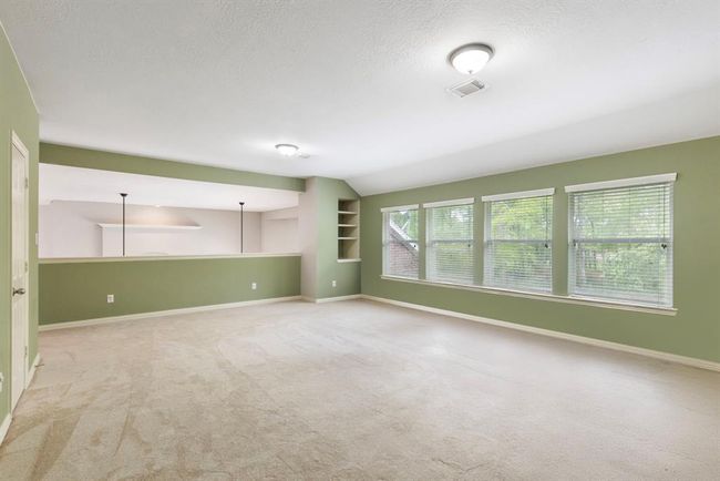 Another view of Game Room with another built-in storage area and closet on the left. | Image 28