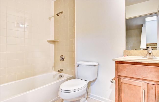 Full bath featuring toilet, baseboards, vanity, and shower combination | Image 30