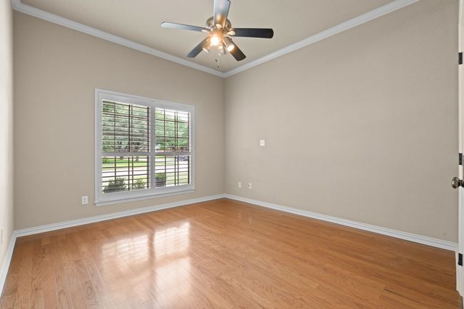 Spare room featuring light wood-style floors, ceiling fan, and ornamental molding | Image 23