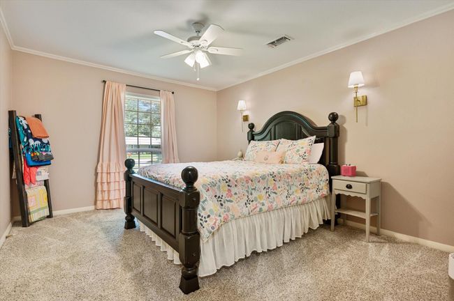 This bedroom overlooks the shady front yard | Image 36