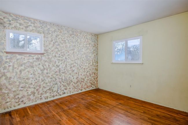 Spare room with plenty of natural light, baseboards, and wood-type flooring | Image 19