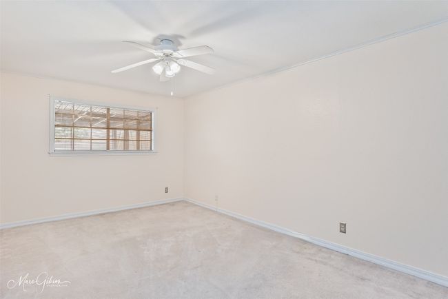 Unfurnished room with light colored carpet, baseboards, and ceiling fan | Image 15