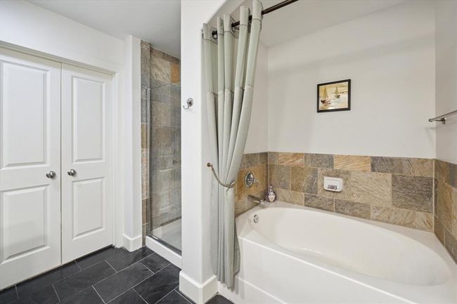 The primary bath includes a relaxing soaking tub and separate walk-in shower for added comfort and convenience. | Image 11