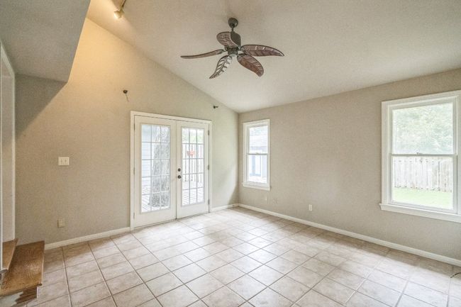 Unfurnished room featuring a ceiling fan, vaulted ceiling, light tile patterned floors, and french doors | Image 11