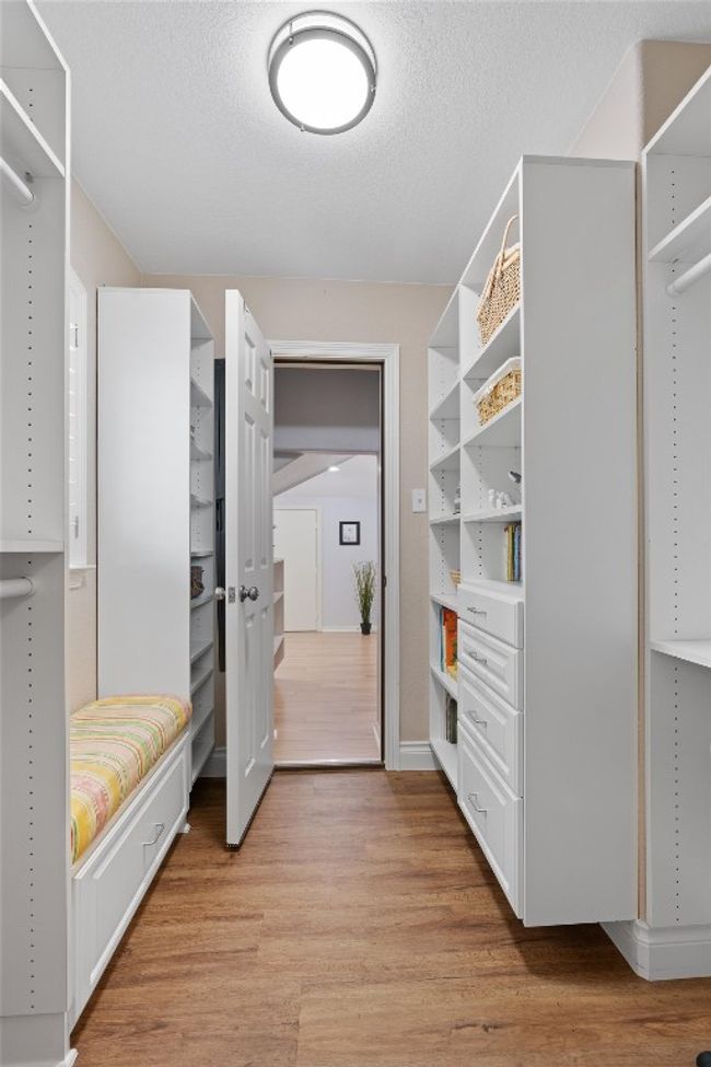 Walk in closet on 3rd bedrooom featuring built in closet system and pathway to "hidden" room | Image 28