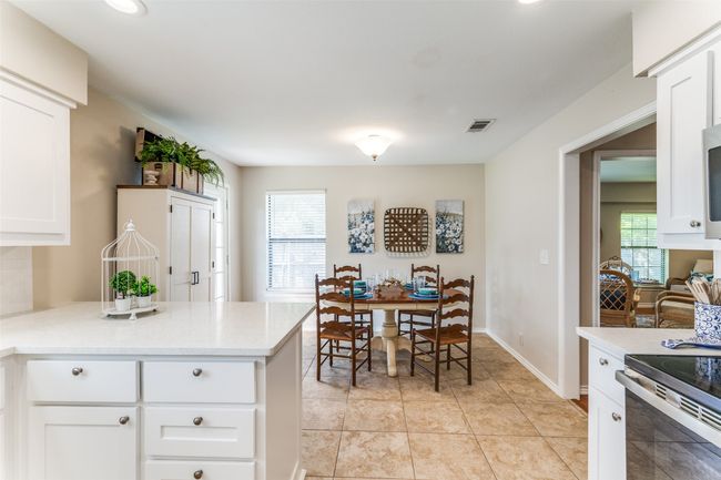 Kitchen with light countertops, healthy amount of natural light, a peninsula, white cabinetry, and recessed lighting | Image 15