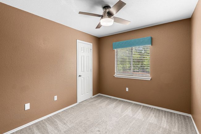 Unfurnished room with a ceiling fan and carpet flooring | Image 19