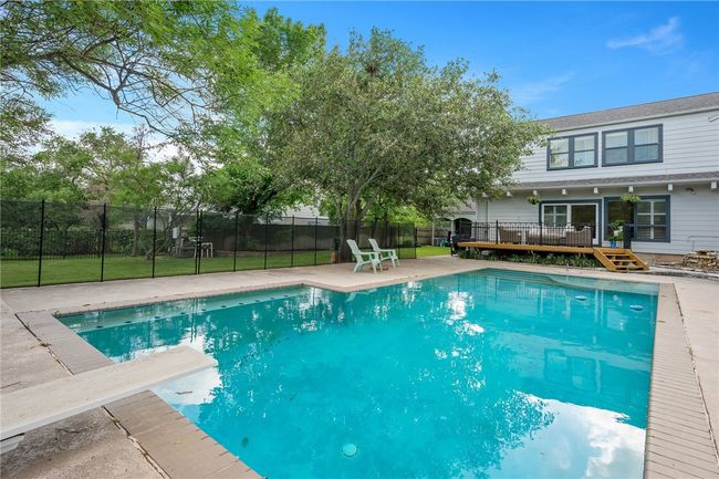 View of pool featuring a wooden deck and a diving board | Image 31