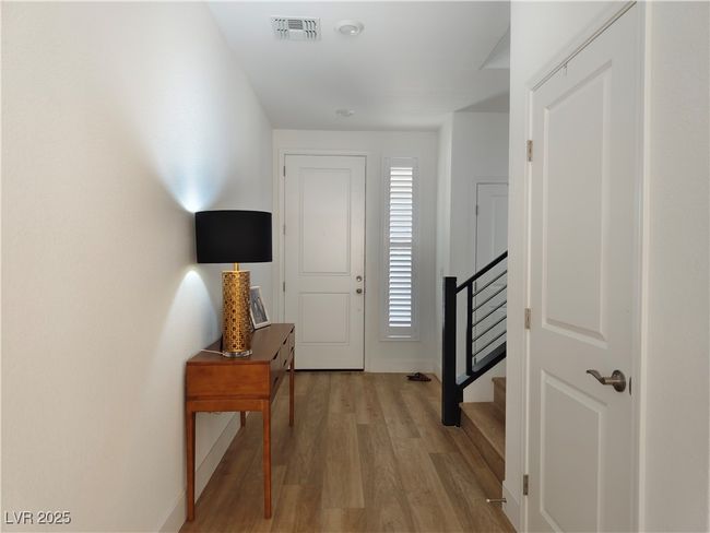 Entryway featuring light wood finished floors, stairs, and baseboards | Image 6