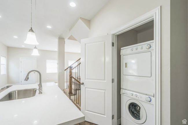 Washroom with stacked washer and clothes dryer, healthy amount of natural light, and recessed lighting | Image 21