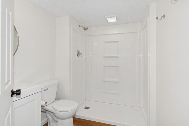 Remodeled lower level bathroom features a new shower stall, vanity and flooring. | Image 19