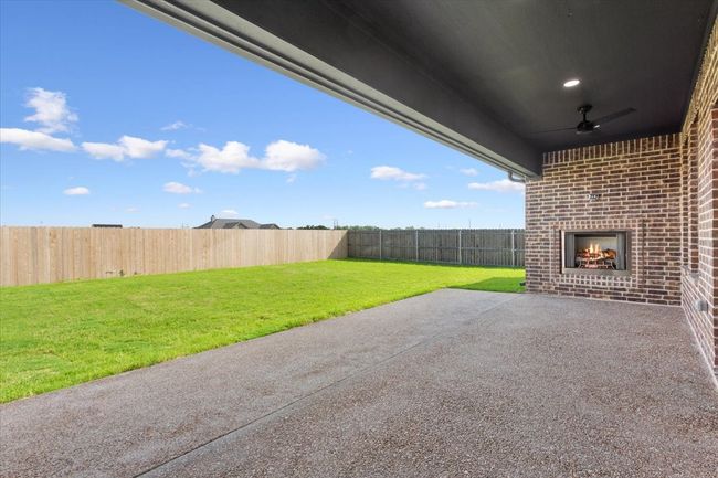 Fenced backyard featuring a patio area and a ceiling fan | Image 35