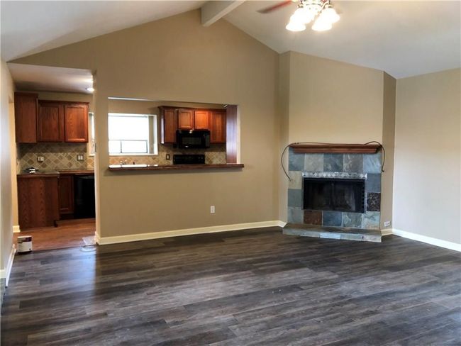 Corner fireplace and access to the kitchen. | Image 4