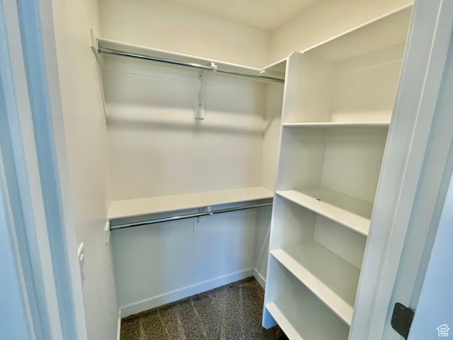 Walk in closet with dark colored carpet | Image 16