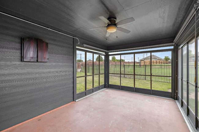 Unfurnished sunroom with a ceiling fan and plenty of natural light | Image 29