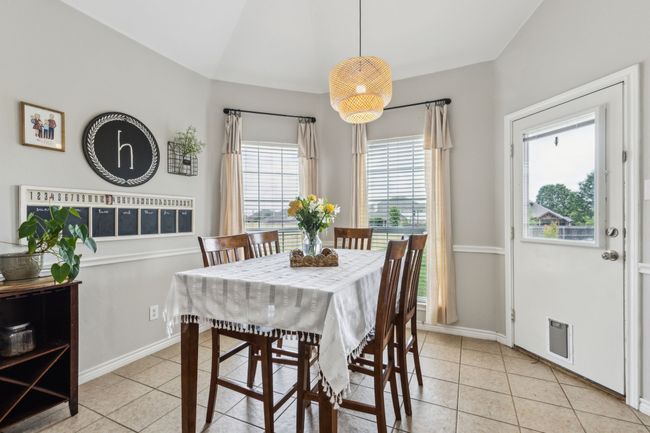 Dining area featuring lofted ceiling, light tile patterned floors | Image 14