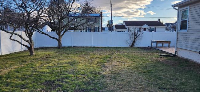 View of yard with a fenced backyard | Image 12