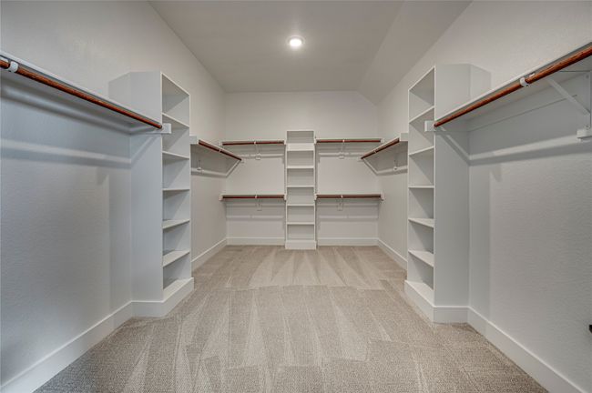 Spacious closet featuring light colored carpet | Image 15