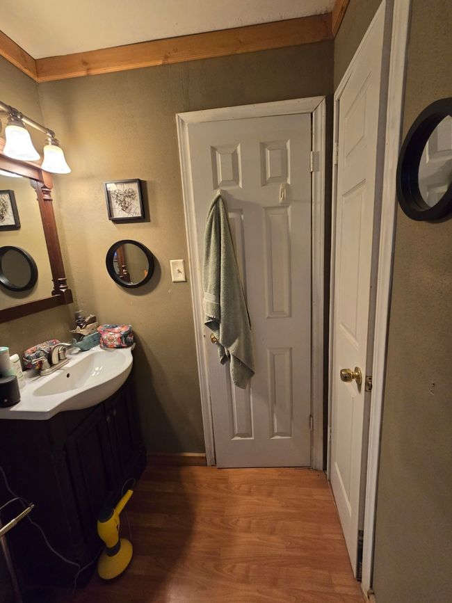 Bathroom with wood finished floors and vanity | Image 27