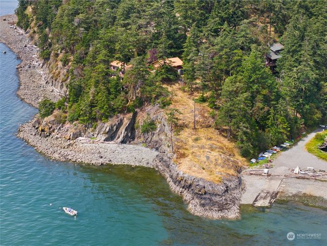You walk down the point to get to the beach at Cook's Cove with it's boat launch. People stash kayaks & rowboats down there. There's picnic tables, too. You could have your own mooring buoy in front of your house. | Image 30
