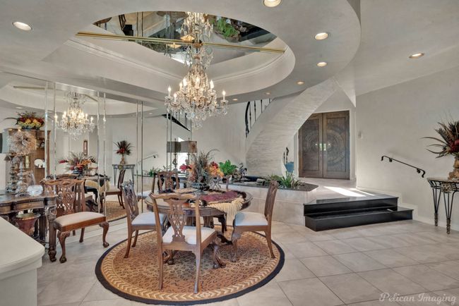 Dining space with tile patterned floors, stairs, a notable chandelier, and recessed lighting | Image 7