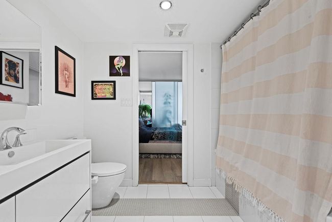 Ensuite bathroom with vanity, ensuite bath, tile patterned flooring, visible vents, and toilet | Image 17