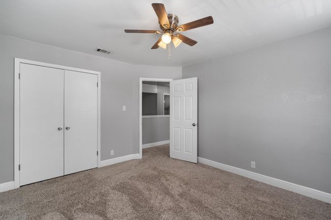 Unfurnished bedroom featuring carpet floors, a closet, and a ceiling fan | Image 23