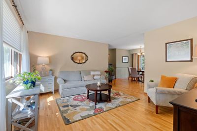 The open main level floor plan between the kitchen, dining area and living room is perfect for gatherings. | Image 3