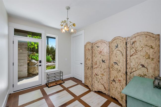 Doorway featuring a chandelier and wood finished floors | Image 51