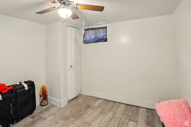 Living area featuring light wood-style floors, ceiling fan, and a textured ceiling | Image 18
