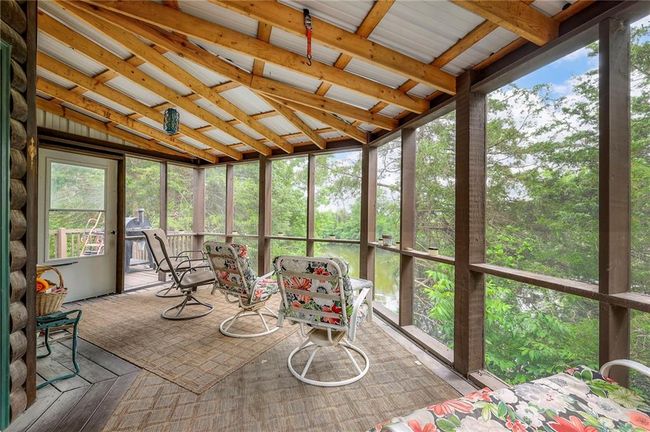 Sunroom / solarium featuring lofted ceiling | Image 42