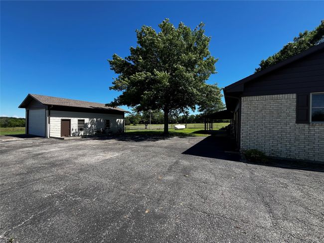 Driveway along north side of home, with shop building (available for lease separately) | Image 27