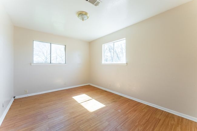 Unfurnished room with baseboards, visible vents, and light wood-type flooring | Image 6